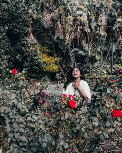 women in trees and flower garden