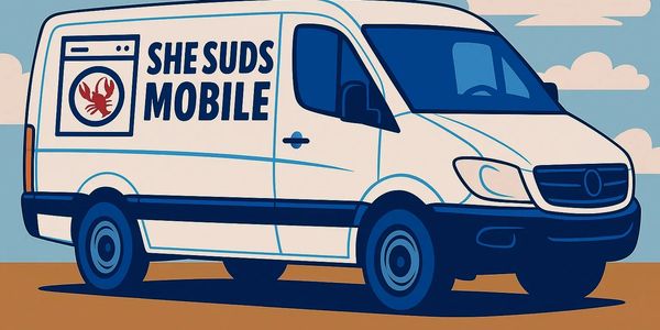 Illustration of a white mobile laundry van with a lobster logo and text 'She Suds Mobile'.