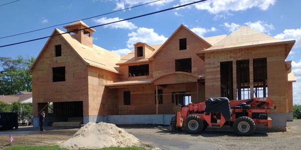 A big tactor machine in front of the Luxury house