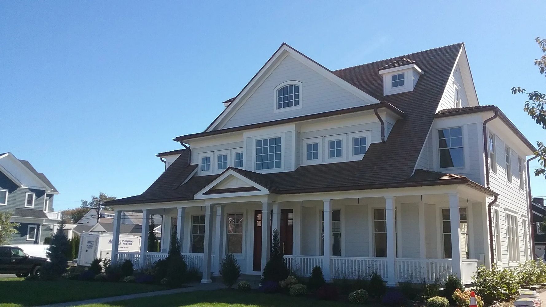 A luxury home is visible from the front and the garden