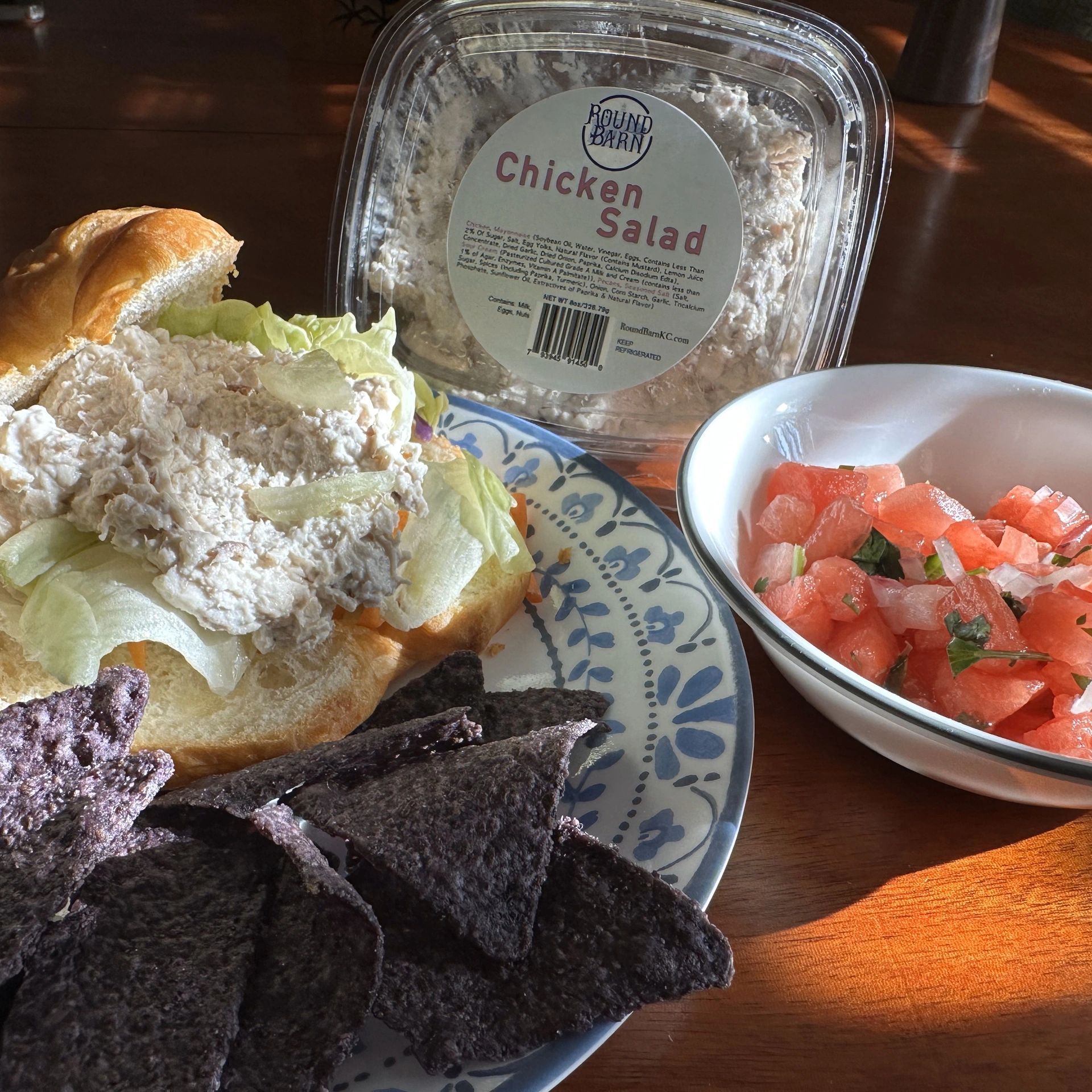 Plate with sandwich, chips, and bowl of salsa
