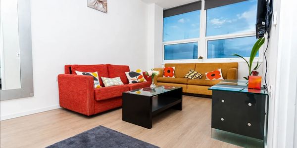 Bright living room with colorful sofas and modern decor.