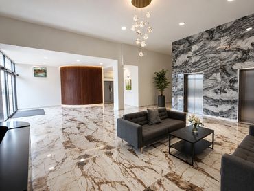 Modern lobby with marble floors and stylish seating.