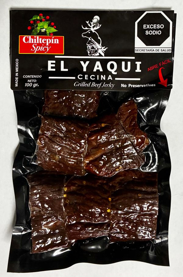 El Yaqui spicy grilled beef jerky in black packaging with chiltepin chili flavor.