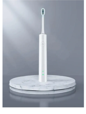 Sleek white electric toothbrush on a marble platform.