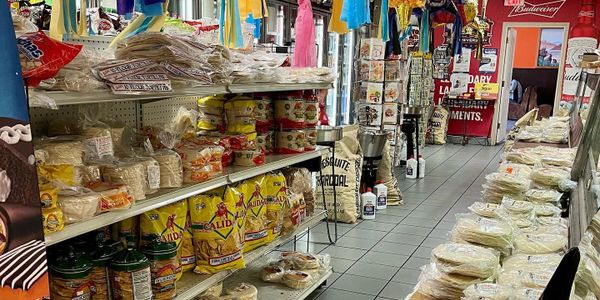 A Mexican grocery store aisle with tortillas and various food items.