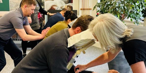 People receiving chair massages indoors.