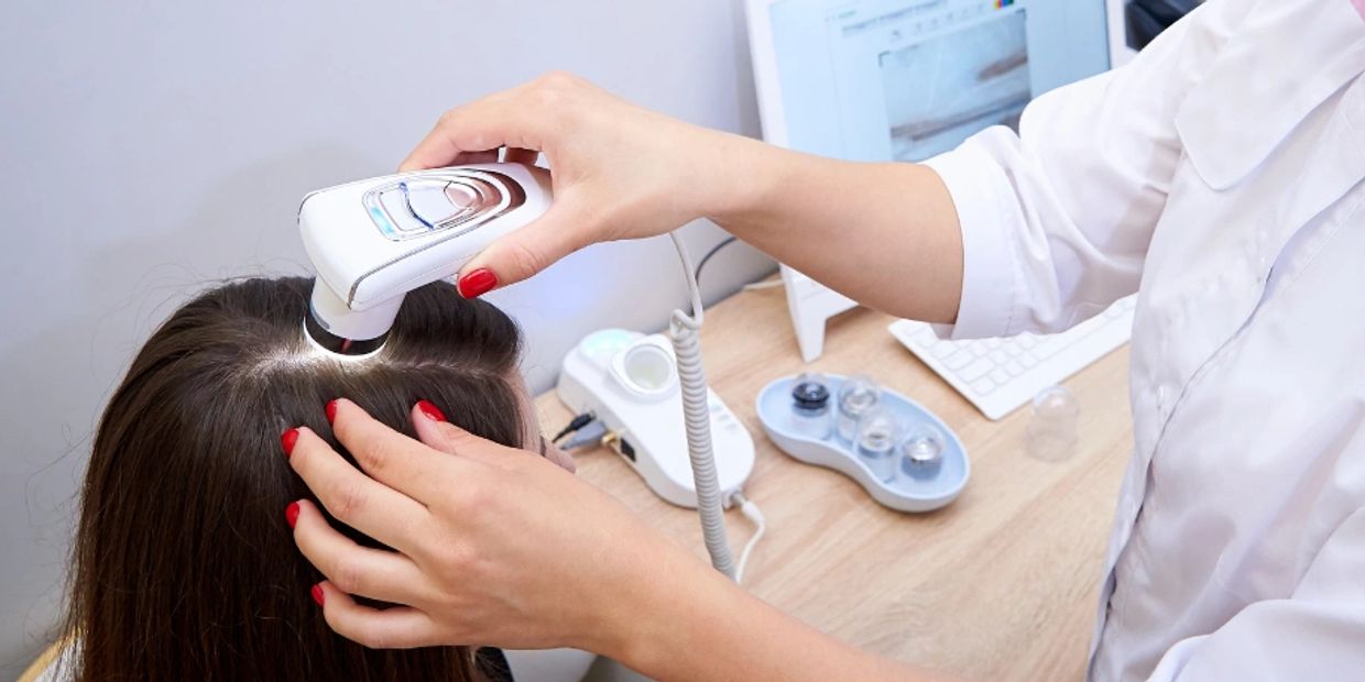 Trichologist performing a scalp analysis