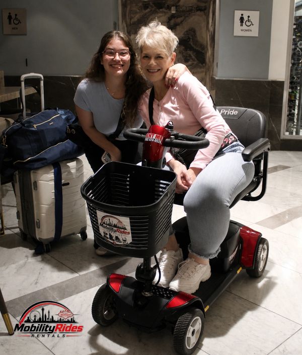 Mom and Daughter recieving their scooter after arriving at the Harrah's hotel and casino.