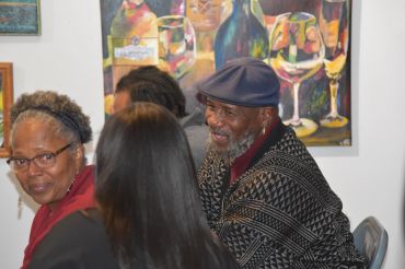 People enjoying conversation at an art gallery.