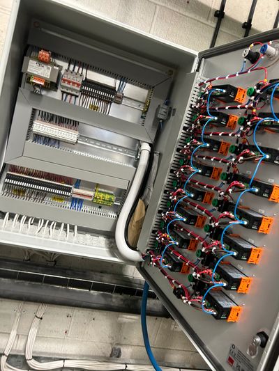 Open electrical control panel with organized wiring and components.