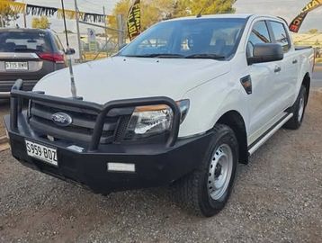 White Ford pickup truck with a bull bar parked outdoors.