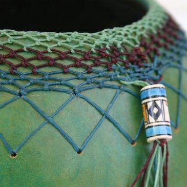 Photograph by Kelly Hazel of a green gourd basket with woven accents. Fine Art Portfolio Photography