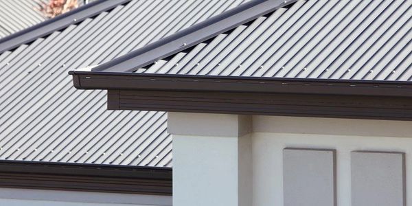 Close-up of modern metal roofing on a house with clean lines and muted colors.
