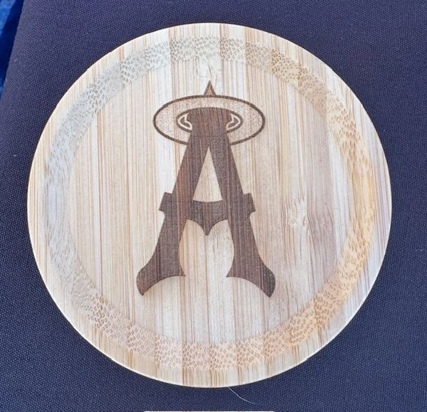 Round wooden coaster with the Los Angeles Angels logo burned in the center.