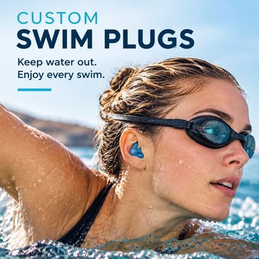 Woman swimming with blue custom swim plugs.