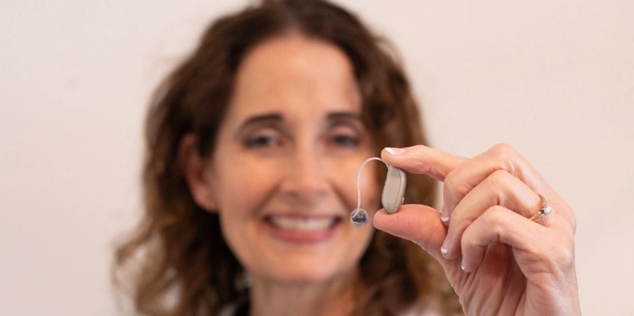 Dr Heather Smith, audiologist, showing a hearing aid