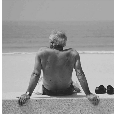 A man relaxed on a beach, feeling confident.
