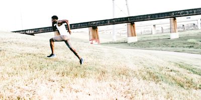 A man sprinting up a hill, utilizing his TRT as a tool to excel him in life. 