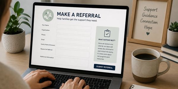 Person filling out a referral form on a laptop.