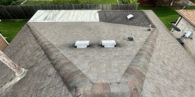 View of a shingled roof with vents from above.