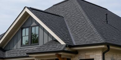 Modern roof with dark shingles and triangular windows.