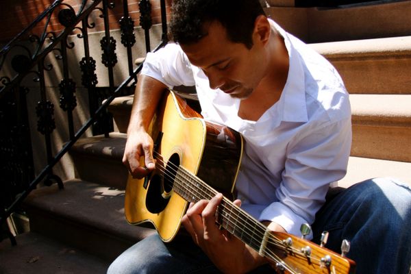 Derek Samuel Reese sitting on a stoop in Brooklyn Heights