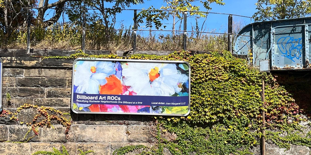 Billboard with fine art on it Flowers, bright colors in an urban landscape creating beauty Rochester