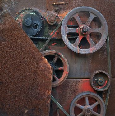 Rusty mechanical gears and pulleys.