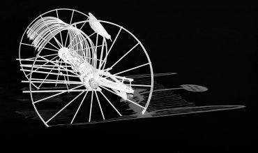 Abstract white wireframe sculpture on black background.