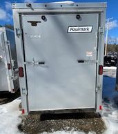 Rear view of a Haulmark enclosed trailer with a closed door.
