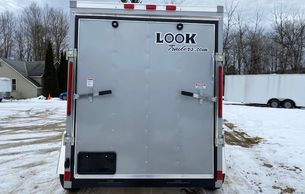 Rear view of a silver enclosed cargo trailer with dual rear doors.
