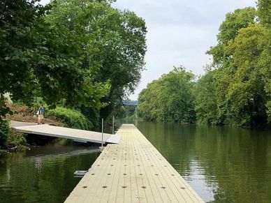 long low profile dock with wide gangway for kayaking, rowing, and canoeing.