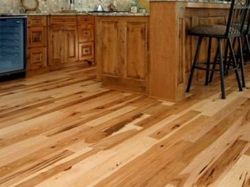 Wooden kitchen floor with natural grain and warm tones.