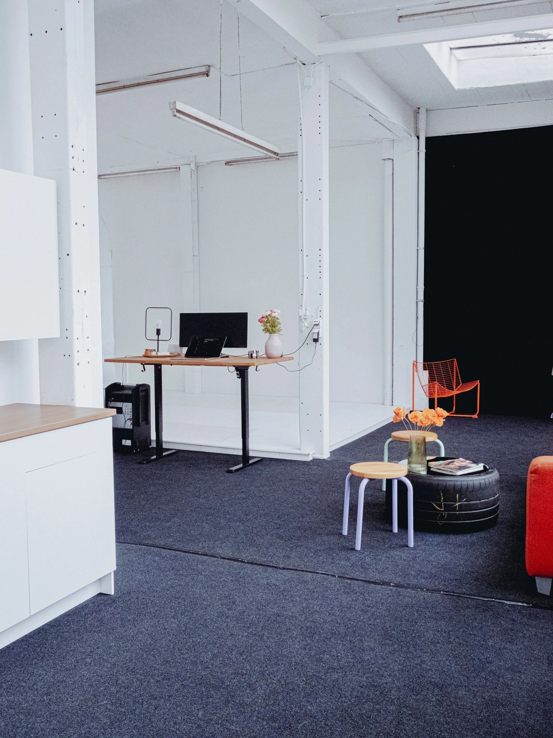 Modern office space with minimalistic furniture and a black tire table.
