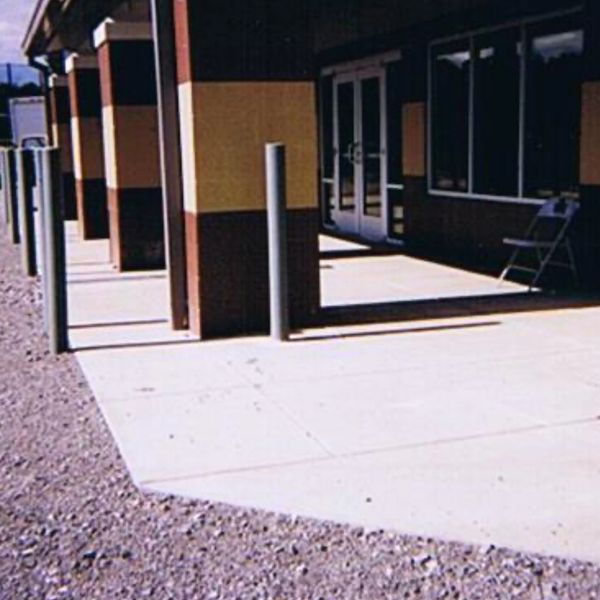 bollards installed with commercial concrete pad entryway at the Knoxville Catholic High School