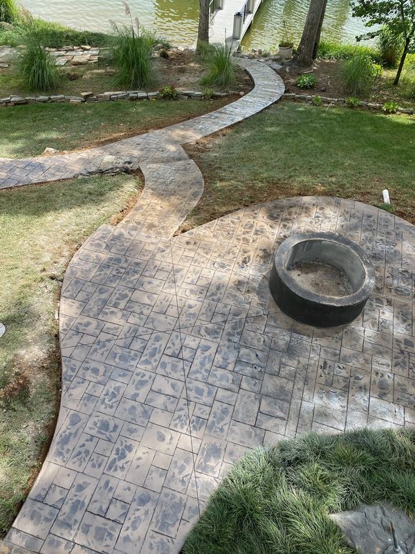 custom concrete fire pit with decorative pad and sidewalks