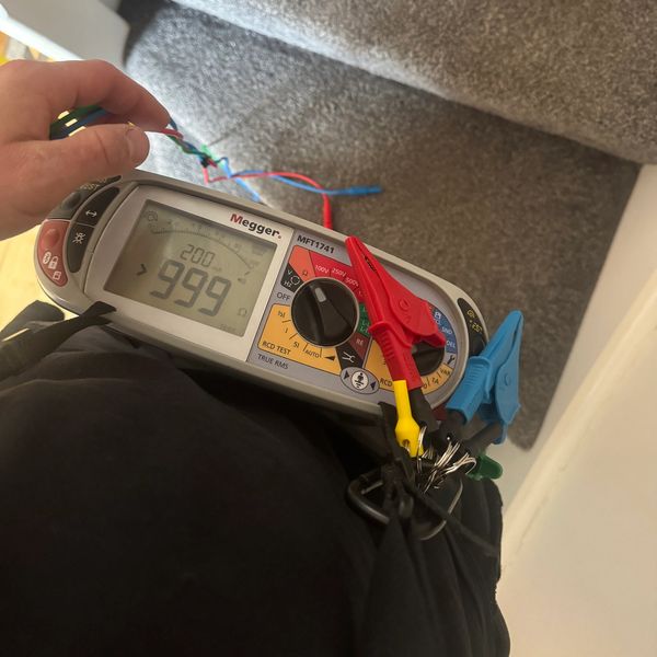 Megger MFT1741 electrical tester showing 999 reading.