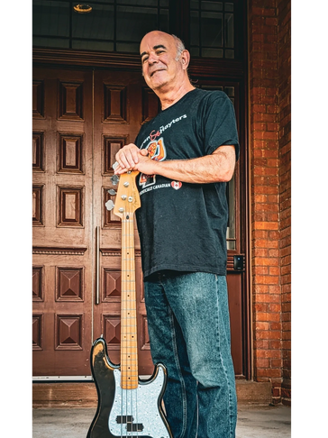 Chris Borg Hayter - playing bass guitar in a rock band playing live music