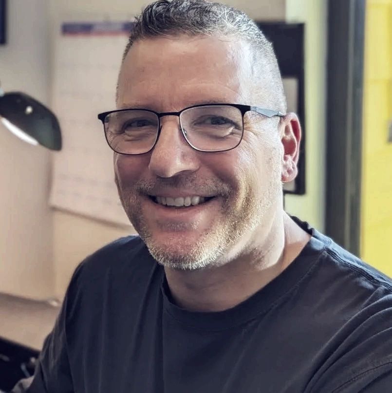 Kirk Laughlin sitting in a workspace