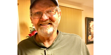 A man smiling in a house