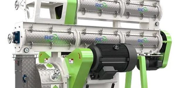 Industrial machine with metallic and green components for processing.