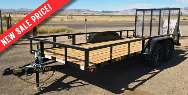 Utility trailer with wooden bed and metal frame, advertised with a new sale price.