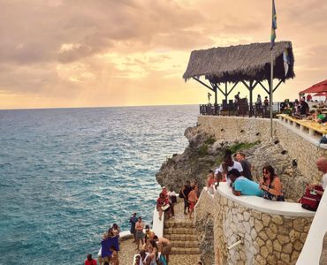 People chilling at Rick's Cafe while the sun is setting