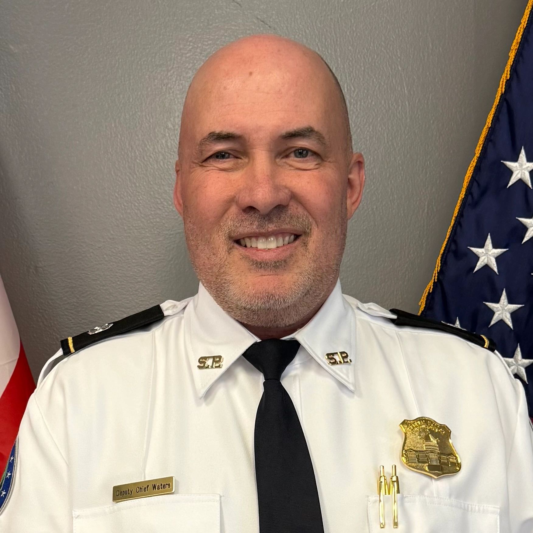 Deputy Chief Waters in uniform smiling.