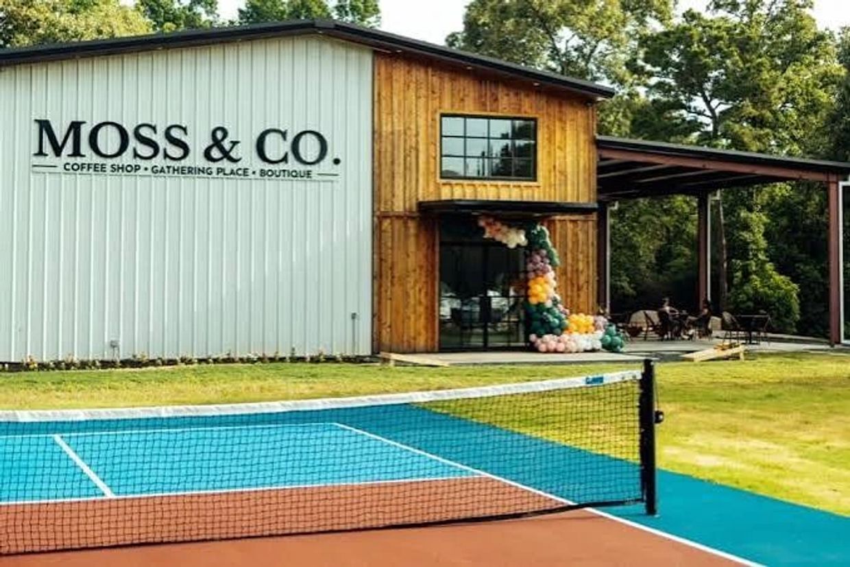 Outdoor tennis court next to Moss &amp; Co. coffee shop.