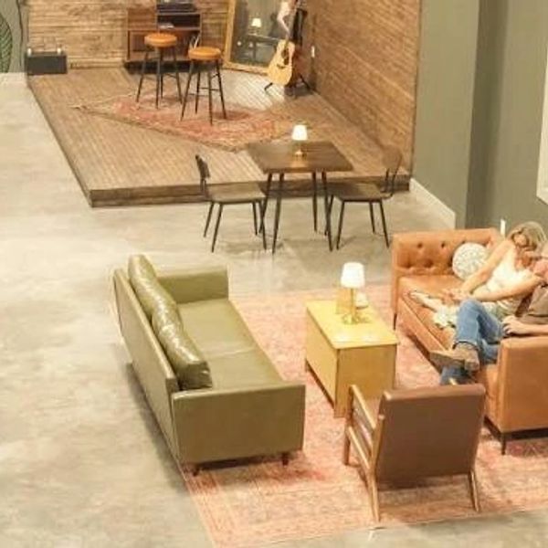 Cozy living room with couches and a stage area.