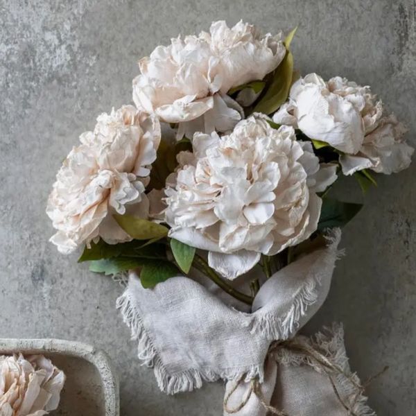 Elegant bouquet of pale pink peonies wrapped in rustic linen, beautiful unique rustic designs