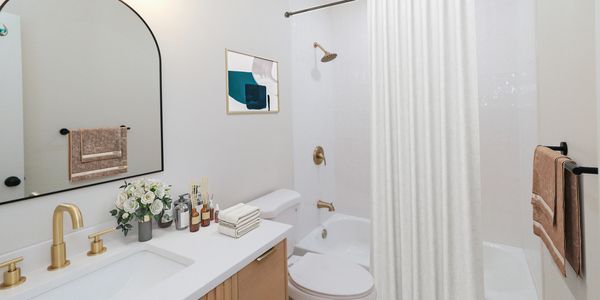Fully renovated top to bottom with a large designer vanity, luxury tile, & modern light fixtures.
