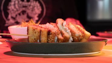 Plate of fried sandwiches with dipping sauce.